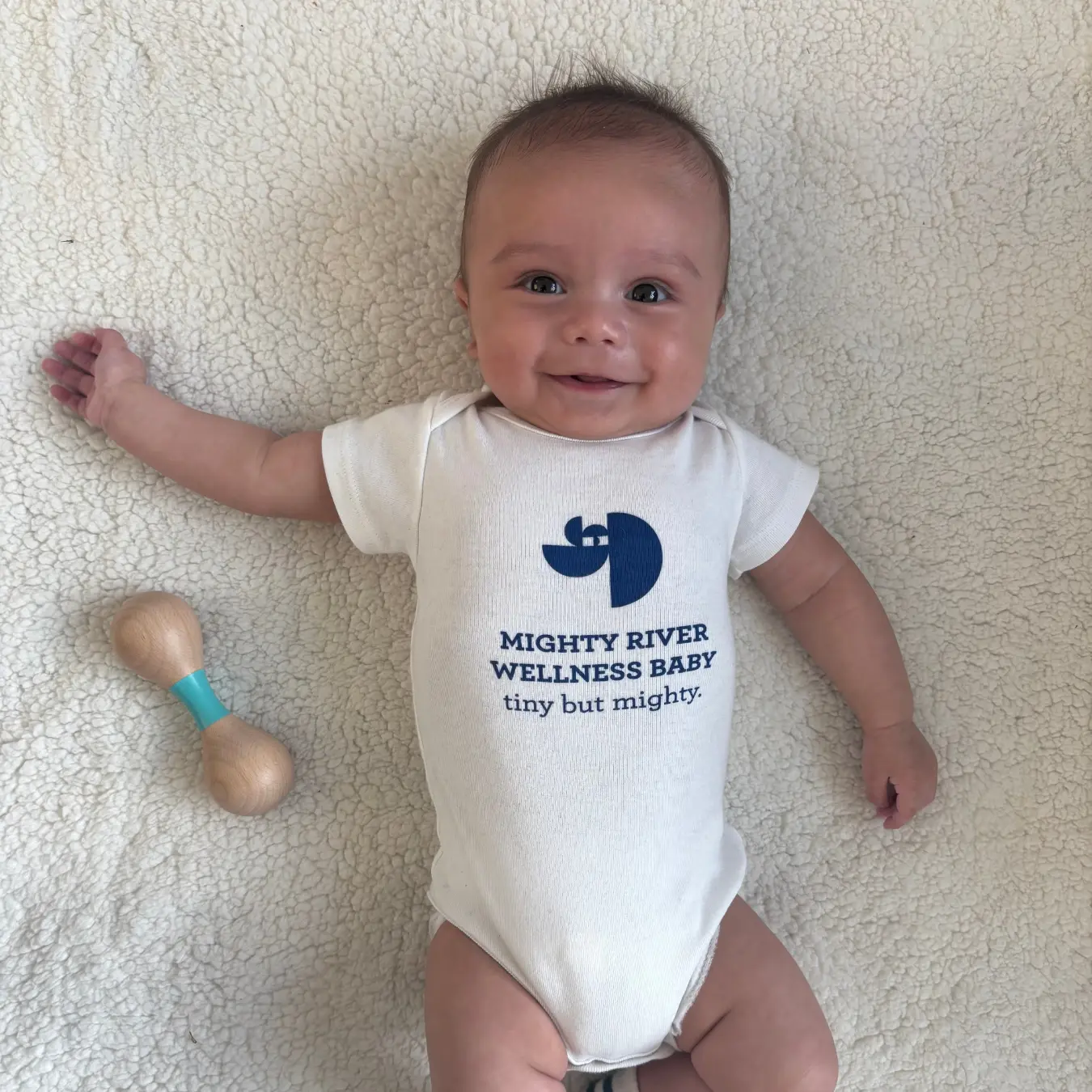 Mighty River Wellness baby onesie representing IVF and embryo transfer acupuncture support